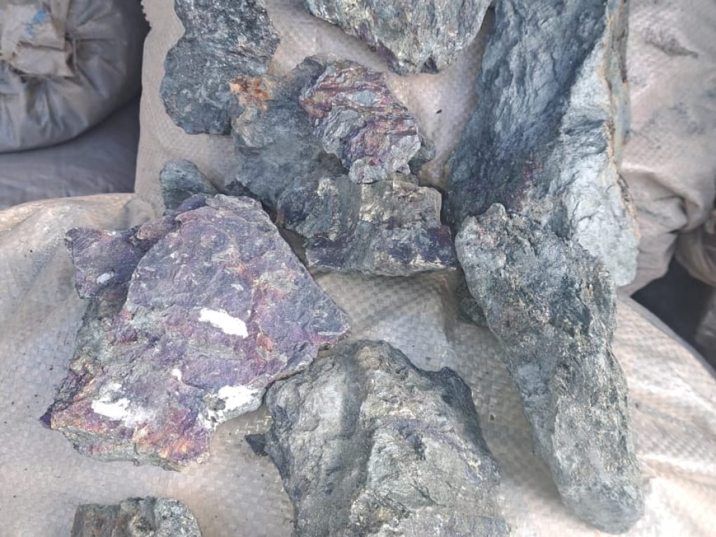 Natural manganese ore in rugged, earthy texture.